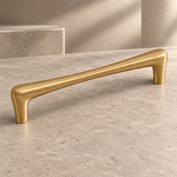 Brushed Brass Teardrop Solid Brass Cabinet Pulls & Knobs on a neutral stone studio background