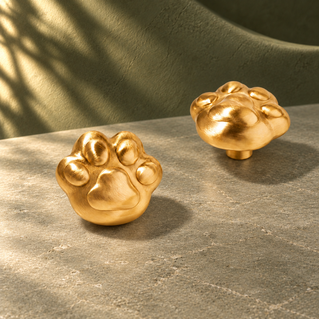 Cute Cat Paw Cabinet Knob — Solid Brass on a deep olive studio background