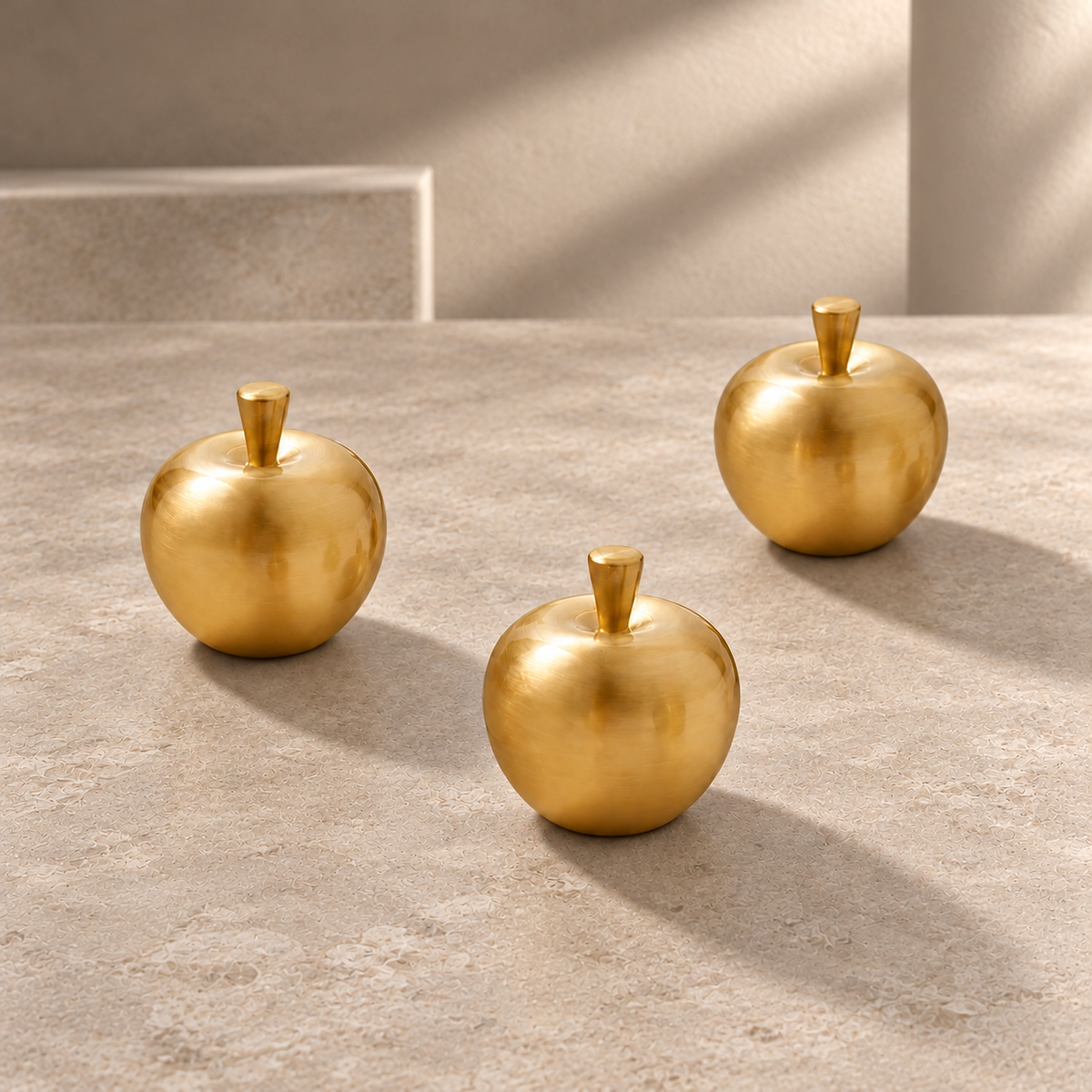 Polished Brass Apple Cabinet Knob — Solid Brass on a neutral stone studio background