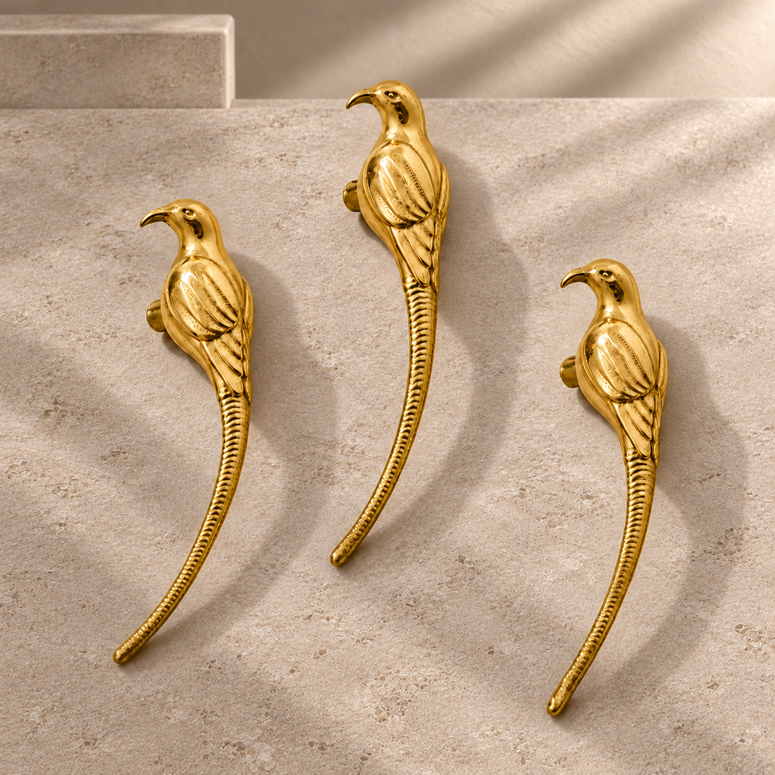 Polished Brass Bird-Design Cabinet Handle — Decorative Accent on a neutral stone studio background