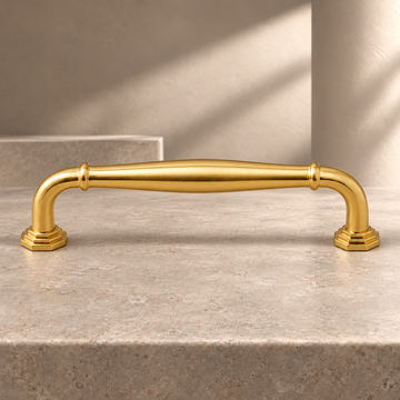 Polished Brass European-Style Cabinet Pulls & Knob — Solid Brass Hardware on a neutral stone studio background