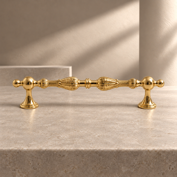 Polished Brass European Solid Brass Cabinet Pulls on a neutral stone studio background