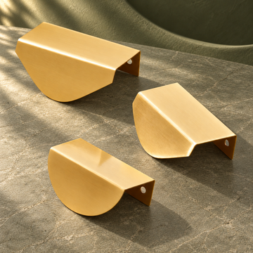 Polished Brass Leaf Edge Pull - Hidden Cabinet Hardware on a deep olive studio background