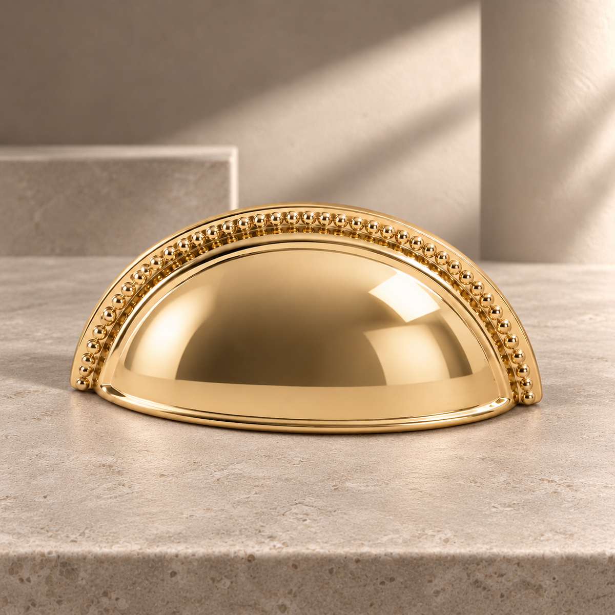 Polished Brass Shell-Shaped Cabinet Pull — Modern Design on a neutral stone studio background