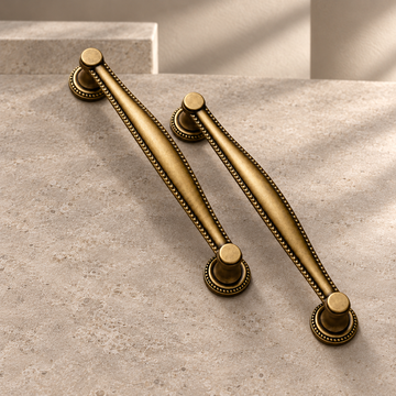 Retro Bronze Cup Handle & Shell Cabinet Knob — Solid Brass on a neutral stone studio background