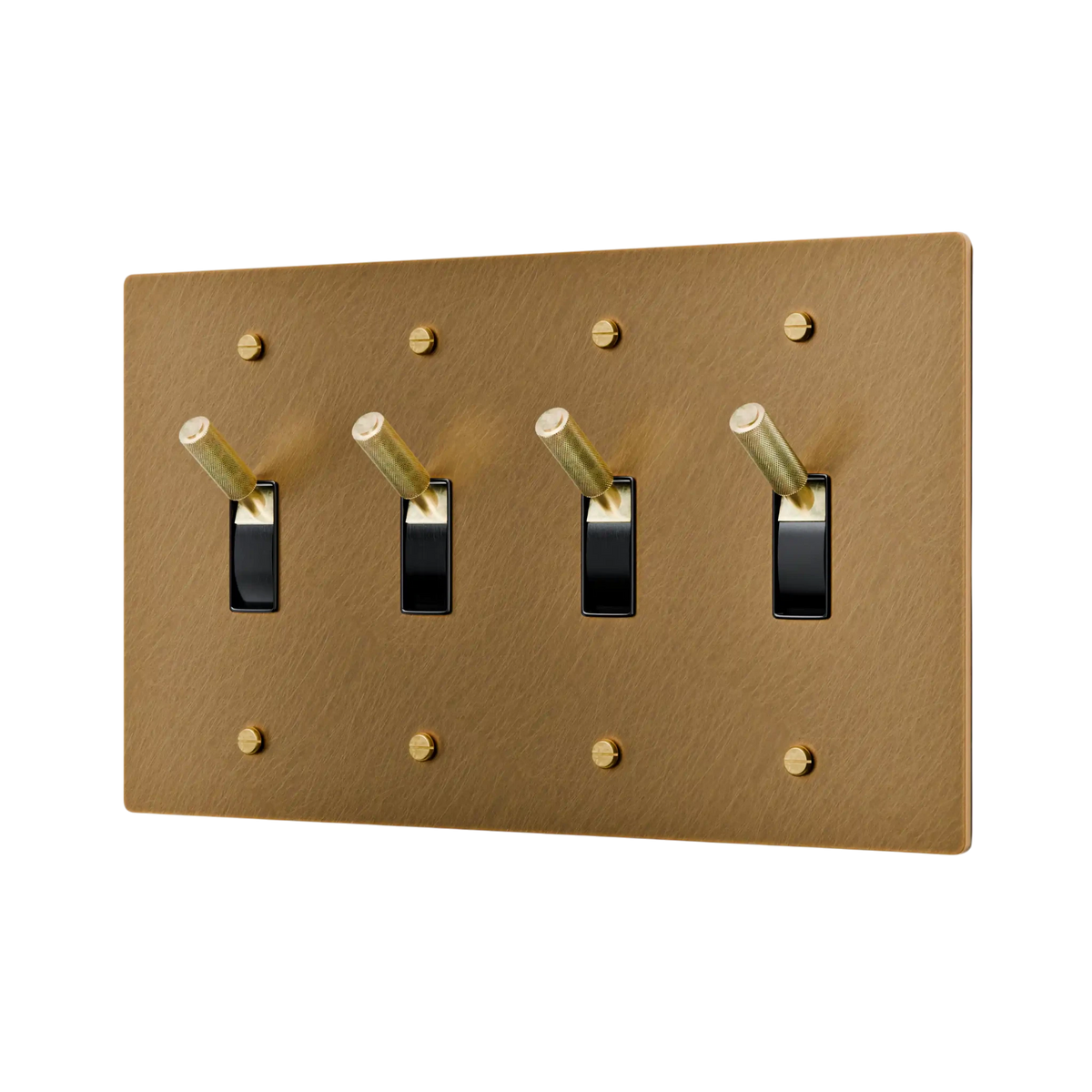 Aged brass light switch panel with four black switches on a white background