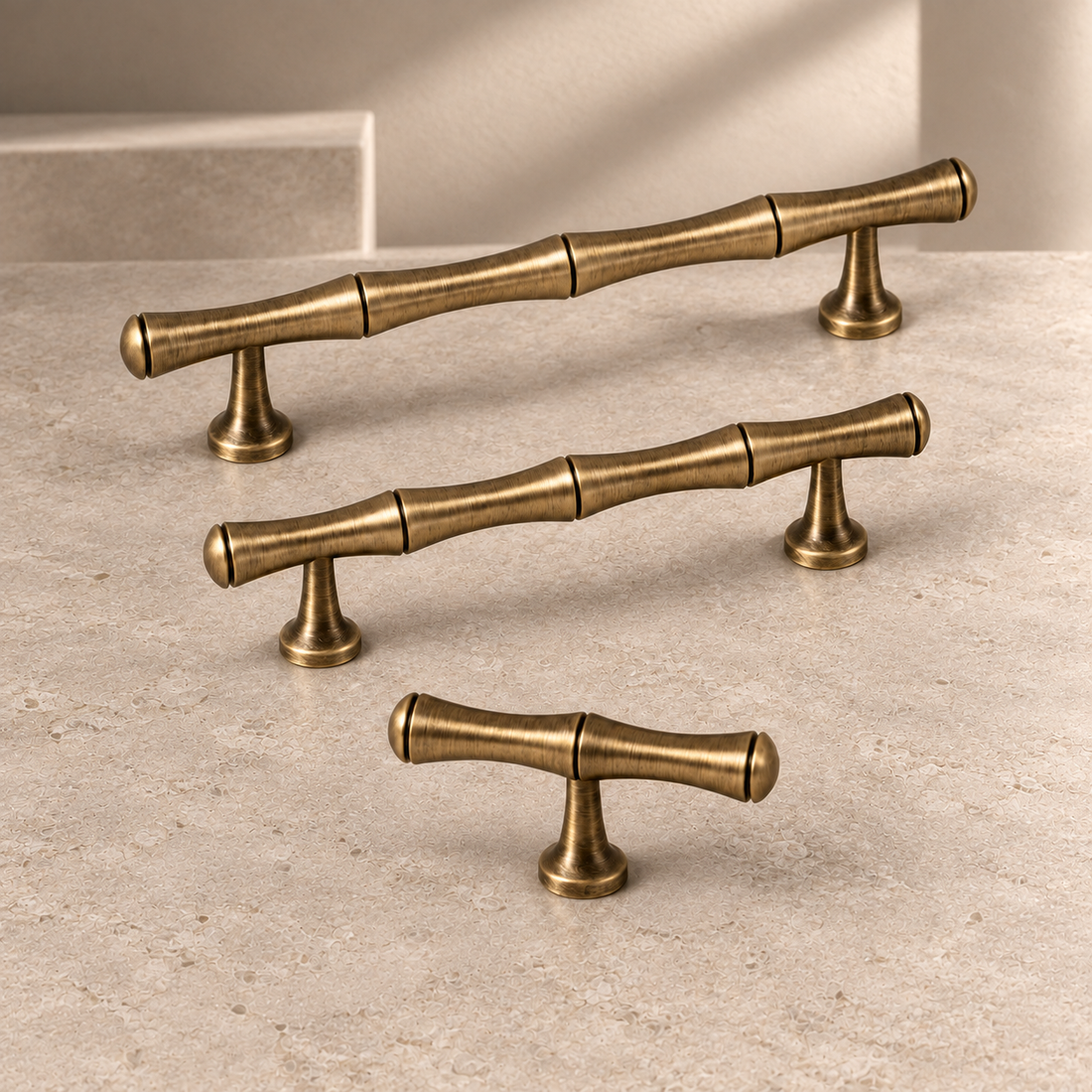 Solid Antique Brass Cabinet Pull & Knob — Bamboo Modern Design on a neutral stone studio background