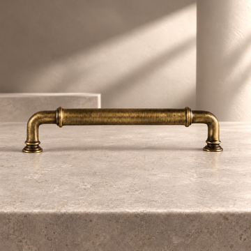 Solid Antique Brass Cabinet Pull & Knob — European Design on a neutral stone studio background