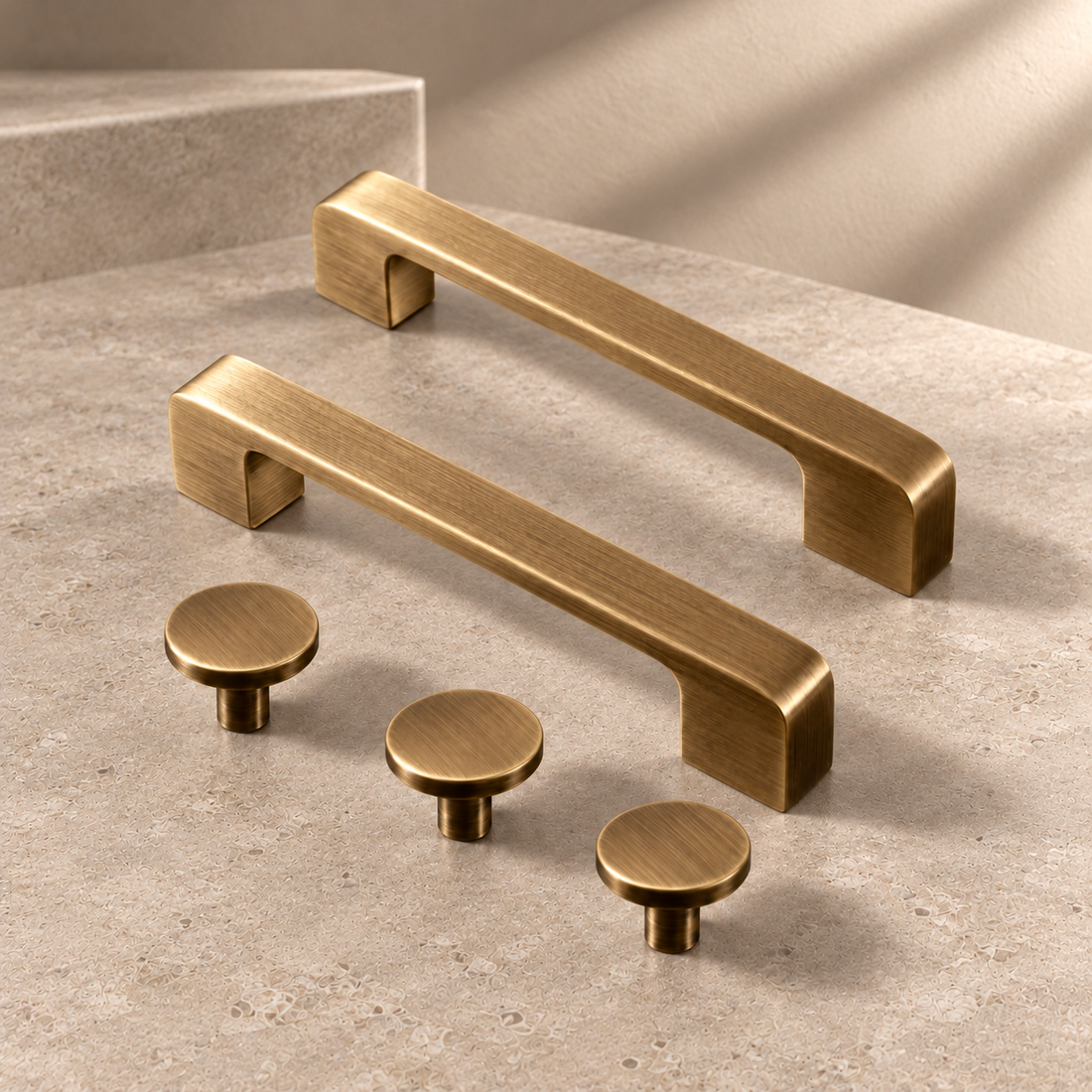 Square Bar Cabinet Pull & Knob — Antique Brass on a neutral stone studio background