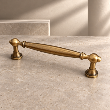 Solid Antique Brass Cabinet Pulls & Knobs — Modern Kitchen & Furniture Hardware on a neutral stone studio background