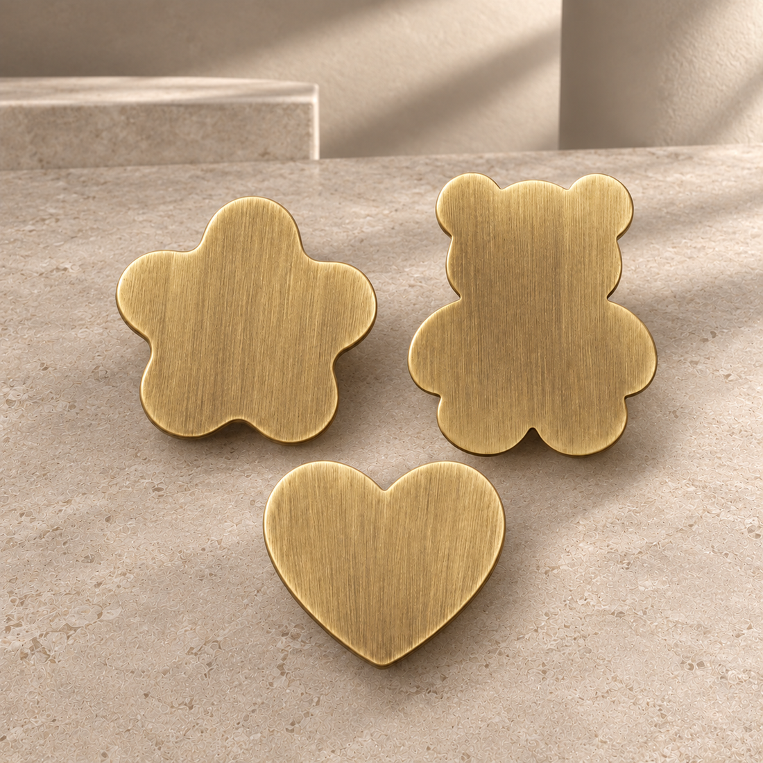 Solid Antique Brass Children’s Cabinet Knobs — Animal & Shape Design on a neutral stone studio background