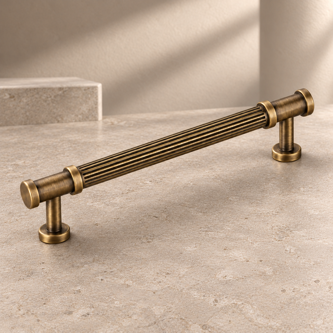 Solid Antique Brass T Bar & Knob Cabinet Pull — Ribbed Romance Design on a neutral stone studio background