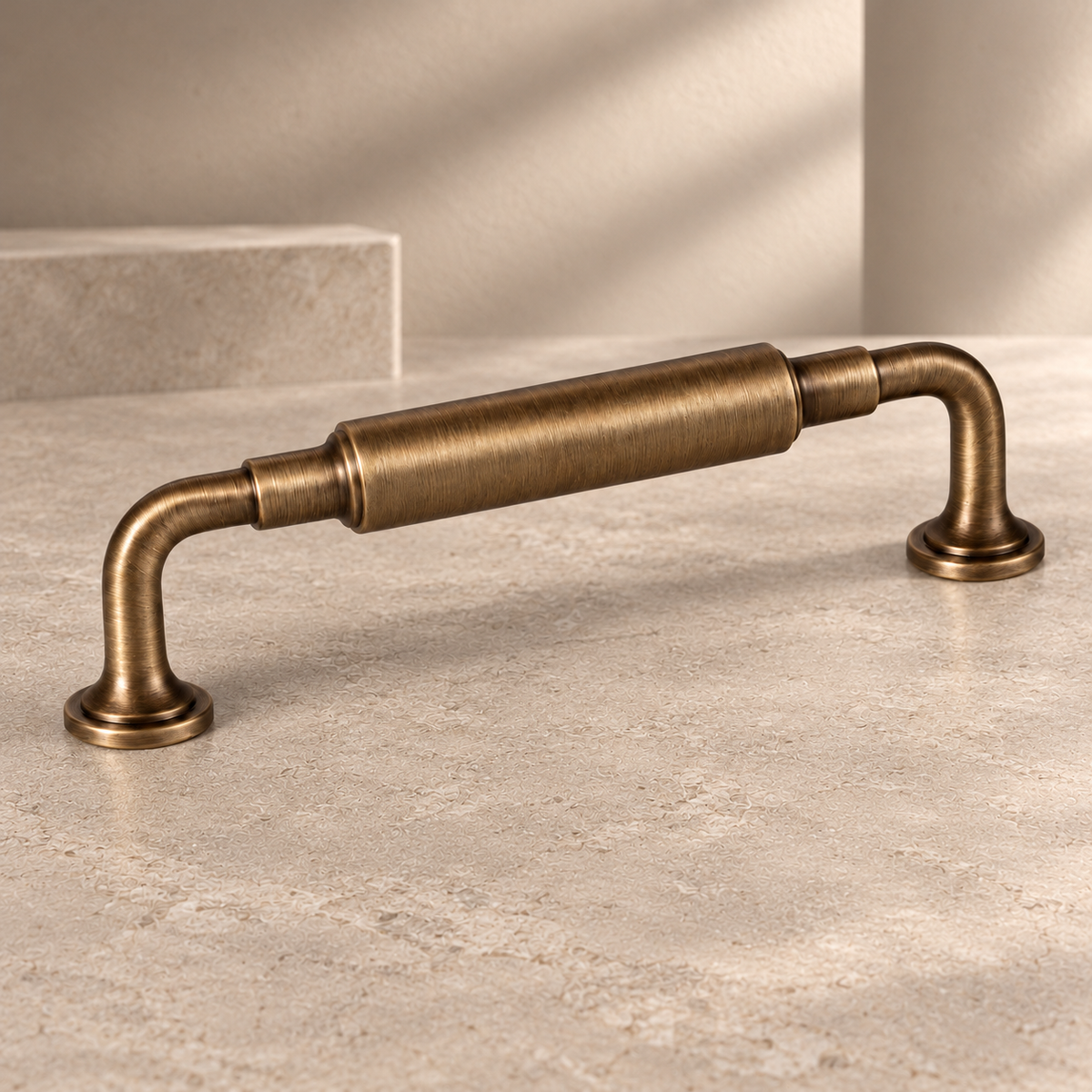 Knuckle Bar Cabinet Pull & Knob — Antique Brass on a neutral stone studio background