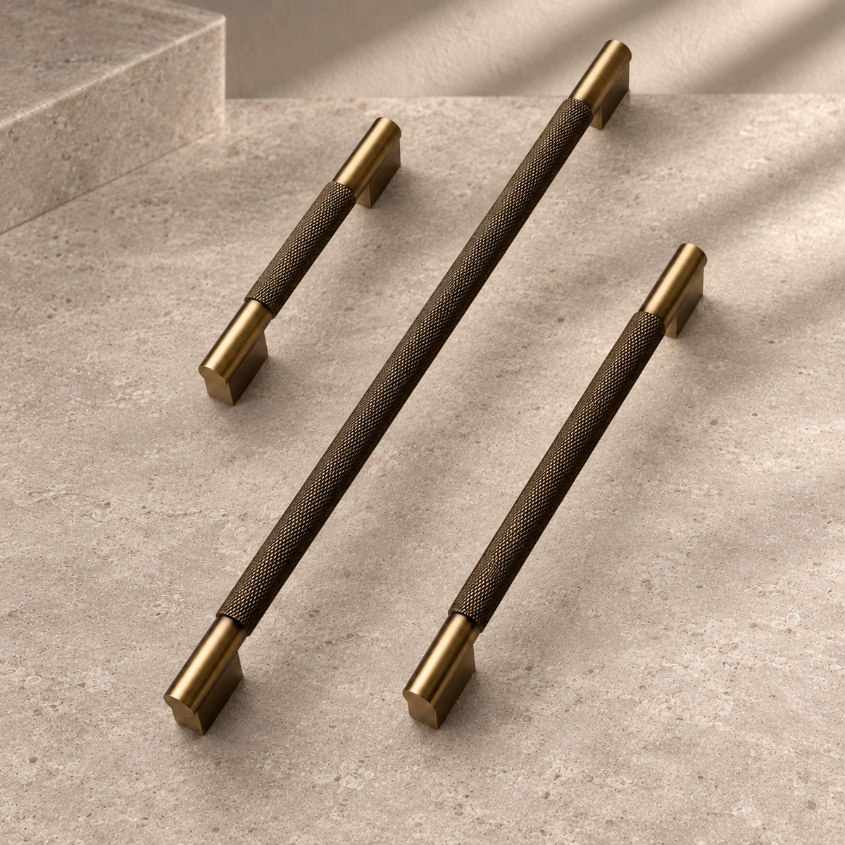 Solid Brushed Antique Brass Cabinet Pull & Knob - Cross Knurled Modern Design on a neutral stone studio background