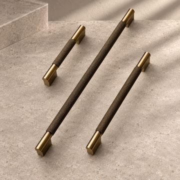 Solid Brushed Antique Brass Cabinet Pull & Knob - Cross Knurled Modern Design on a neutral stone studio background