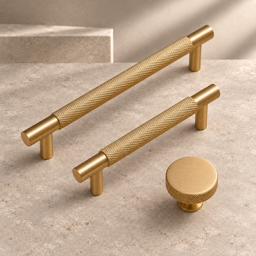 Solid Brushed Brass T Bar & Knob Cabinet Pull — Cross Knurled Design on a neutral stone studio background