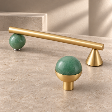 Stone & Brass Cabinet Knobs and Pulls on a neutral stone studio background