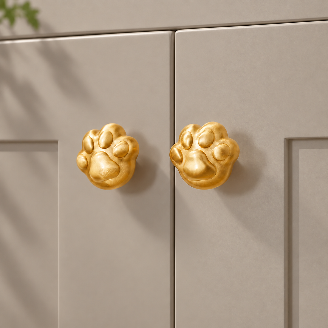 Cute Cat Paw Cabinet Knob — Solid Brass on a deep olive studio background
