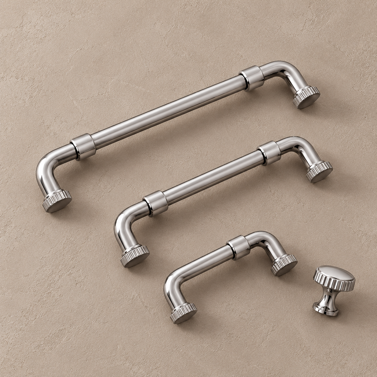 Chrome cabinet pulls and fluted knob on a taupe studio background