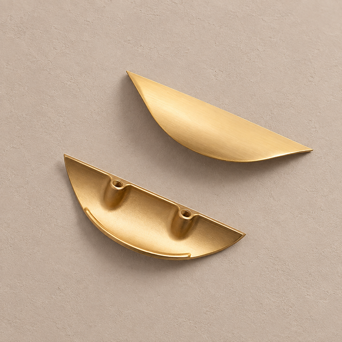 Brushed Brass Cabinet Pulls — Modern Solid Brass Hardware on a neutral stone studio background