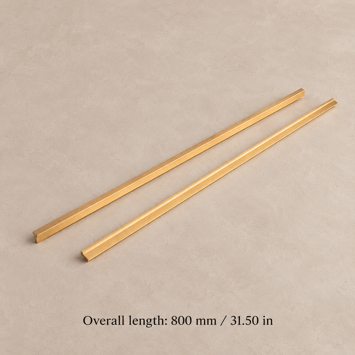 Brushed brass modular cabinet handle, 800 mm overall length, front and reverse profile views on taupe