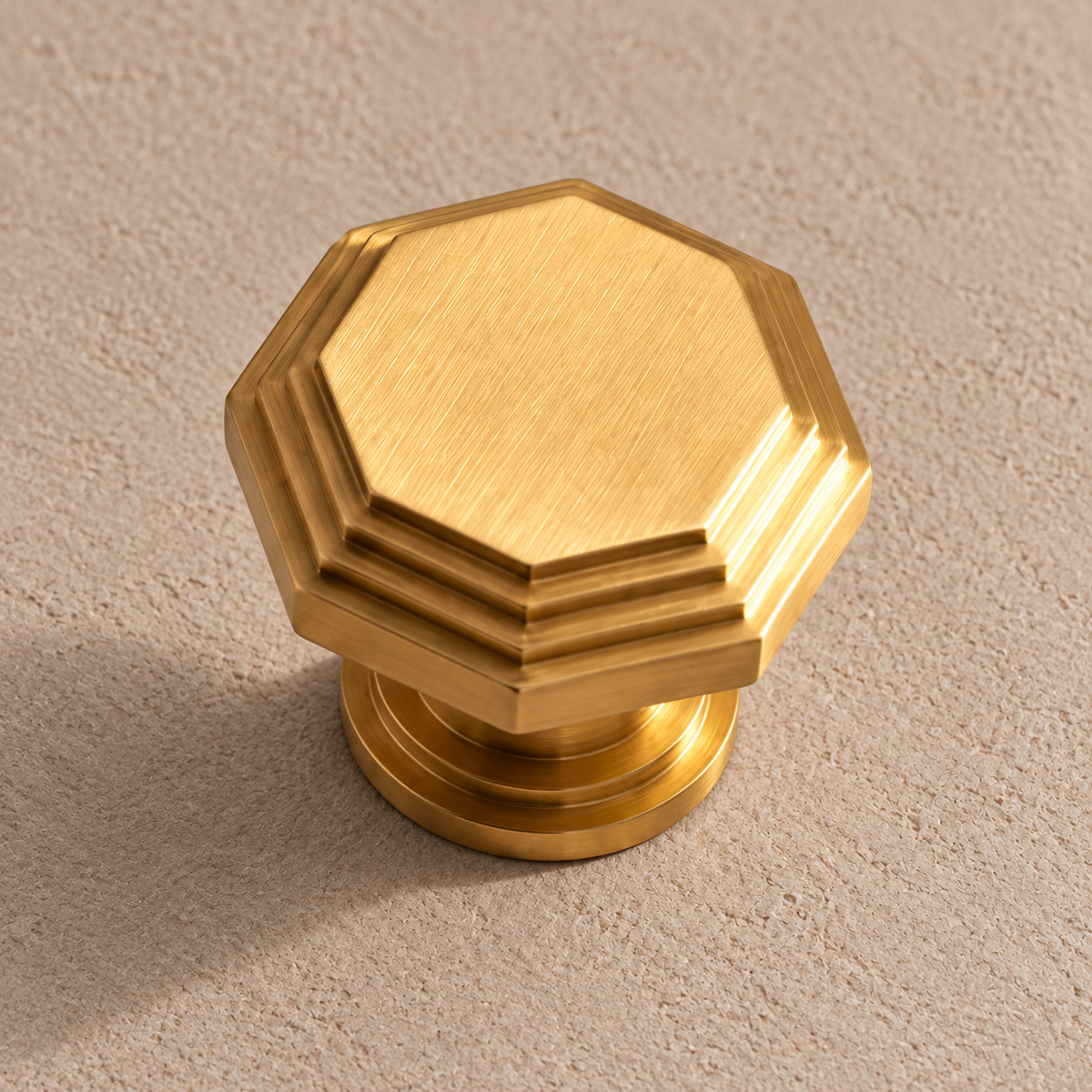 Stepped octagonal brushed brass cabinet knob detail