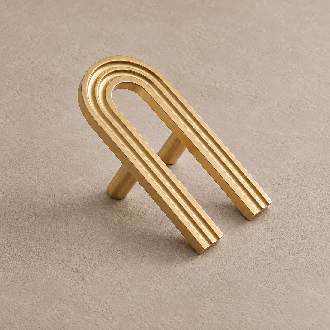 Solid Brushed Brass Cabinet Pull & Knob — Runway Design on a neutral stone studio background