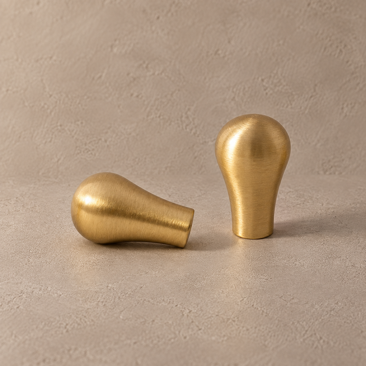 Brushed brass teardrop cabinet knobs upright and side view