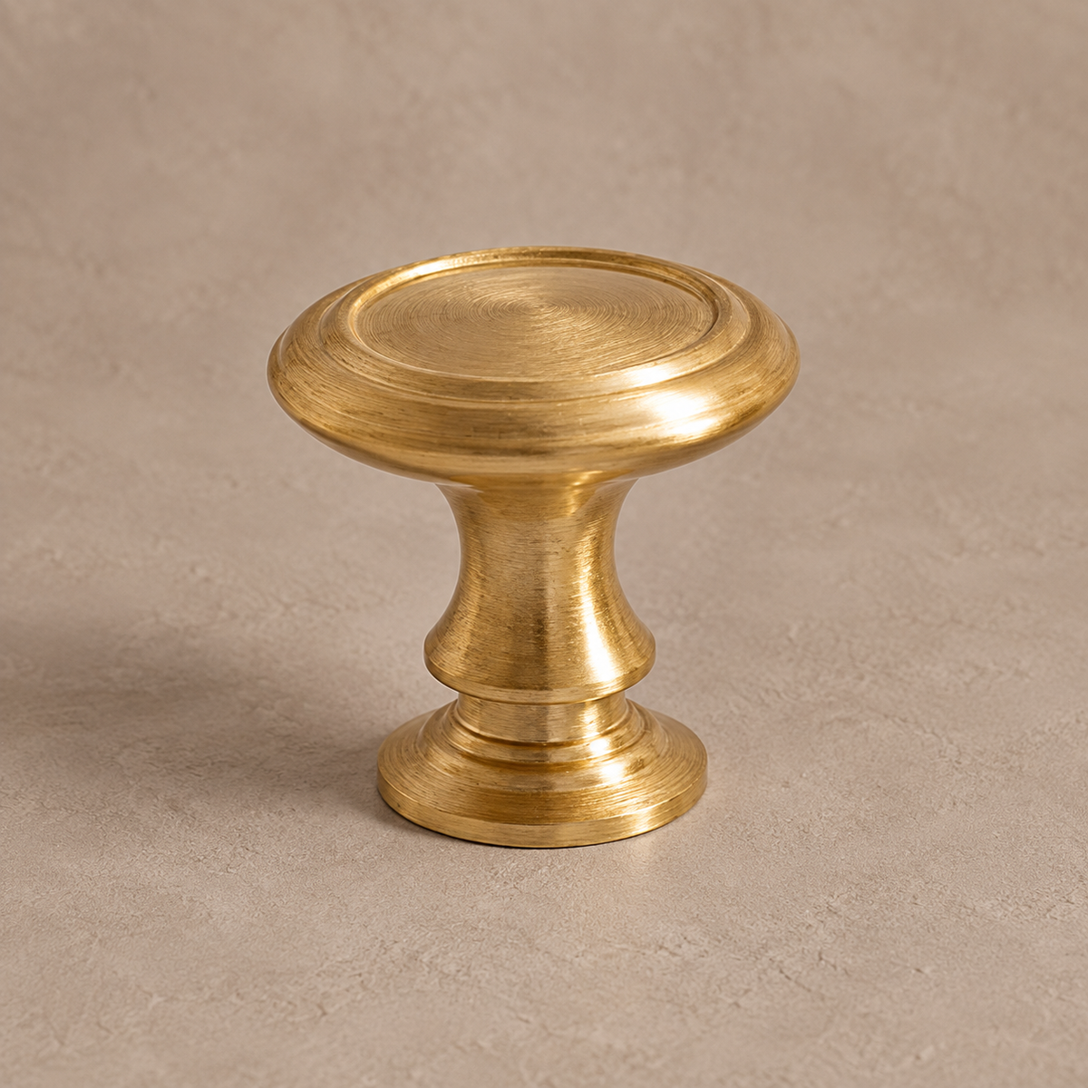 Brushed brass round cabinet knob with concentric rim detail