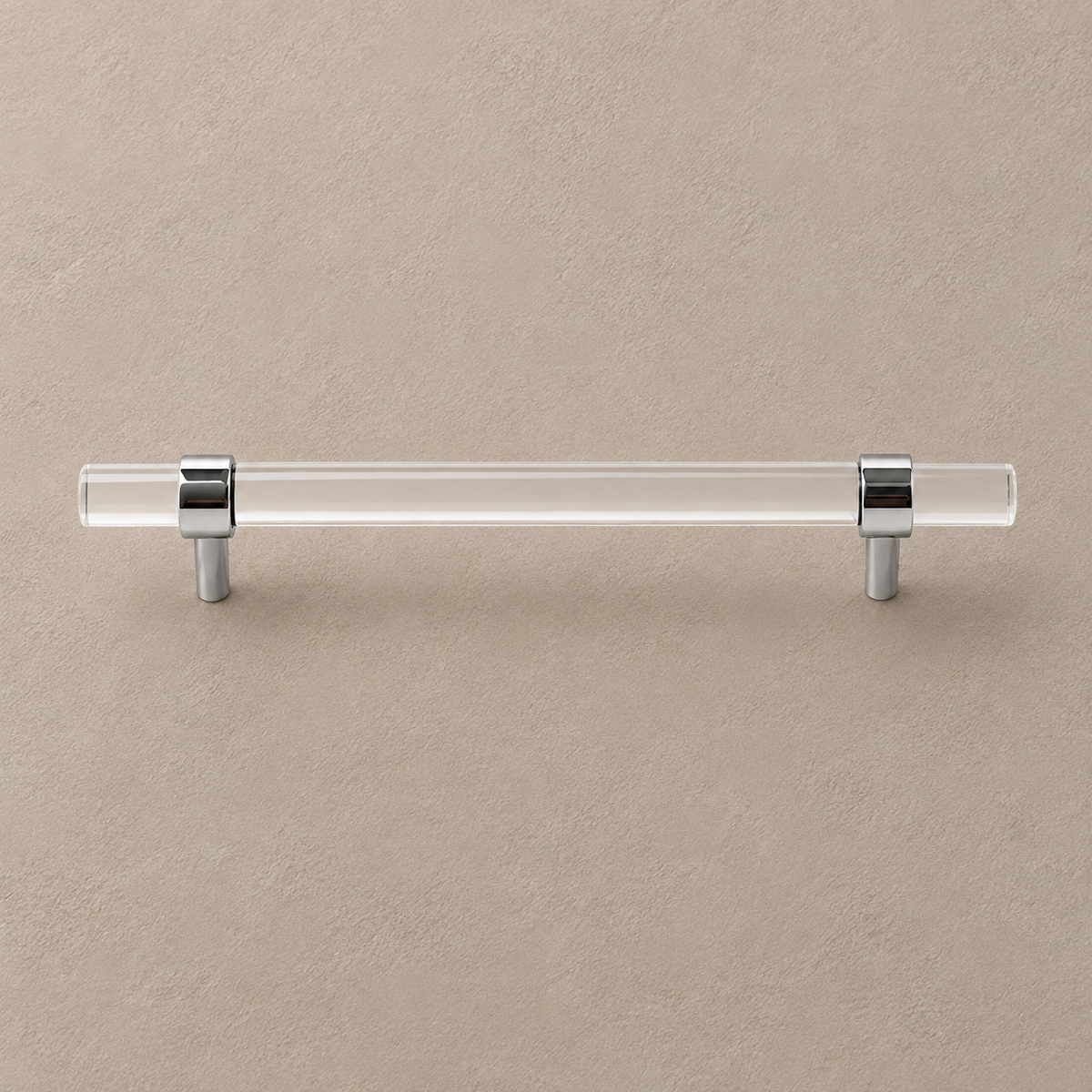 Clear acrylic cabinet pulls with polished chrome posts on warm taupe plaster