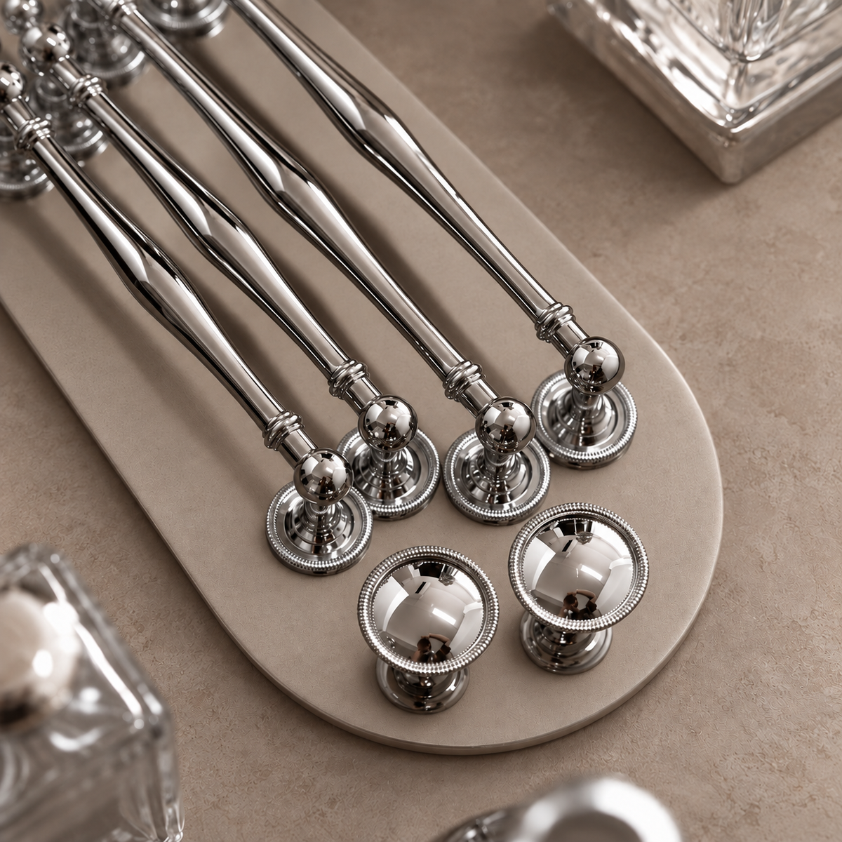 Chrome cabinet hardware detail showing tapered bars and beaded bases