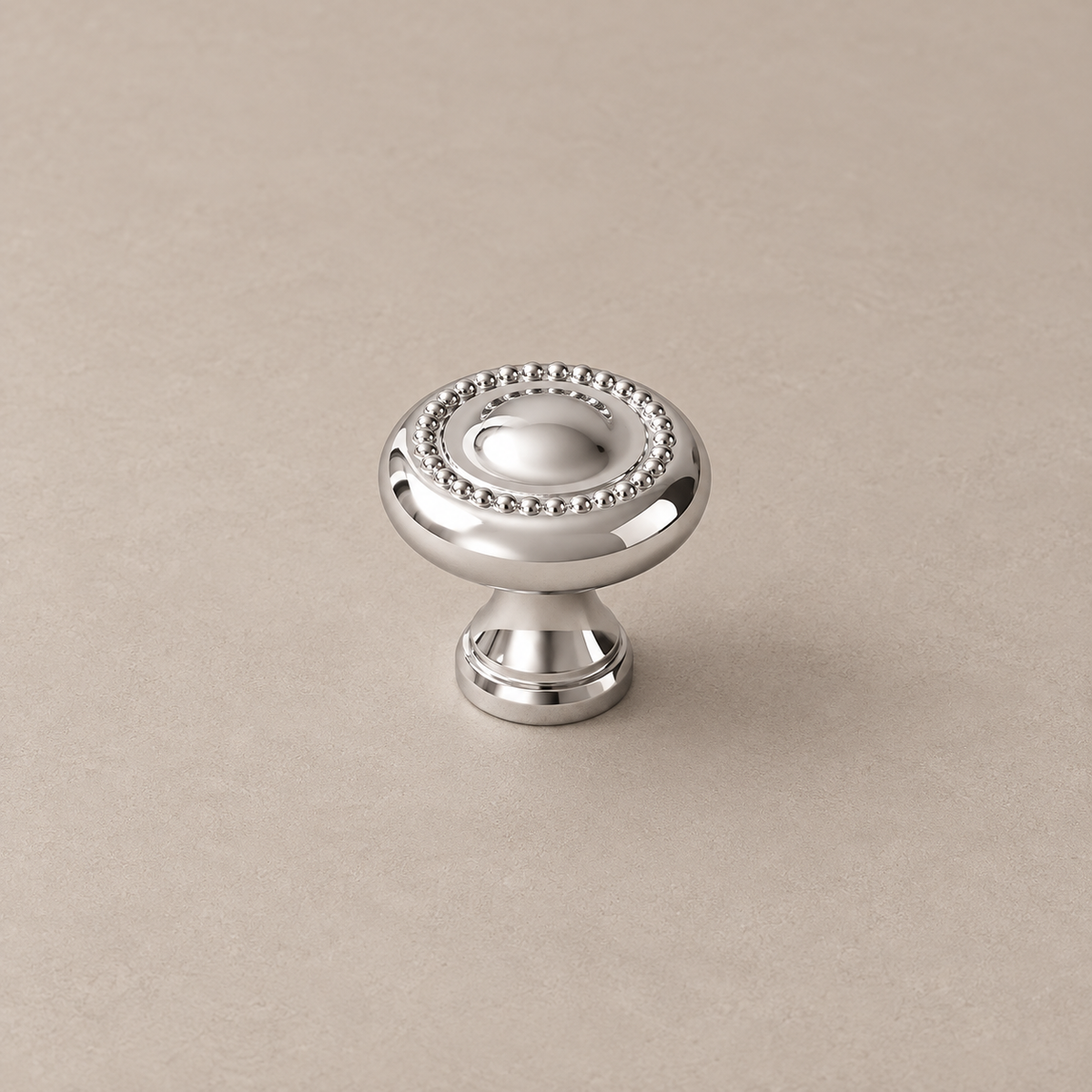 chrome beaded round knob on warm taupe studio surface