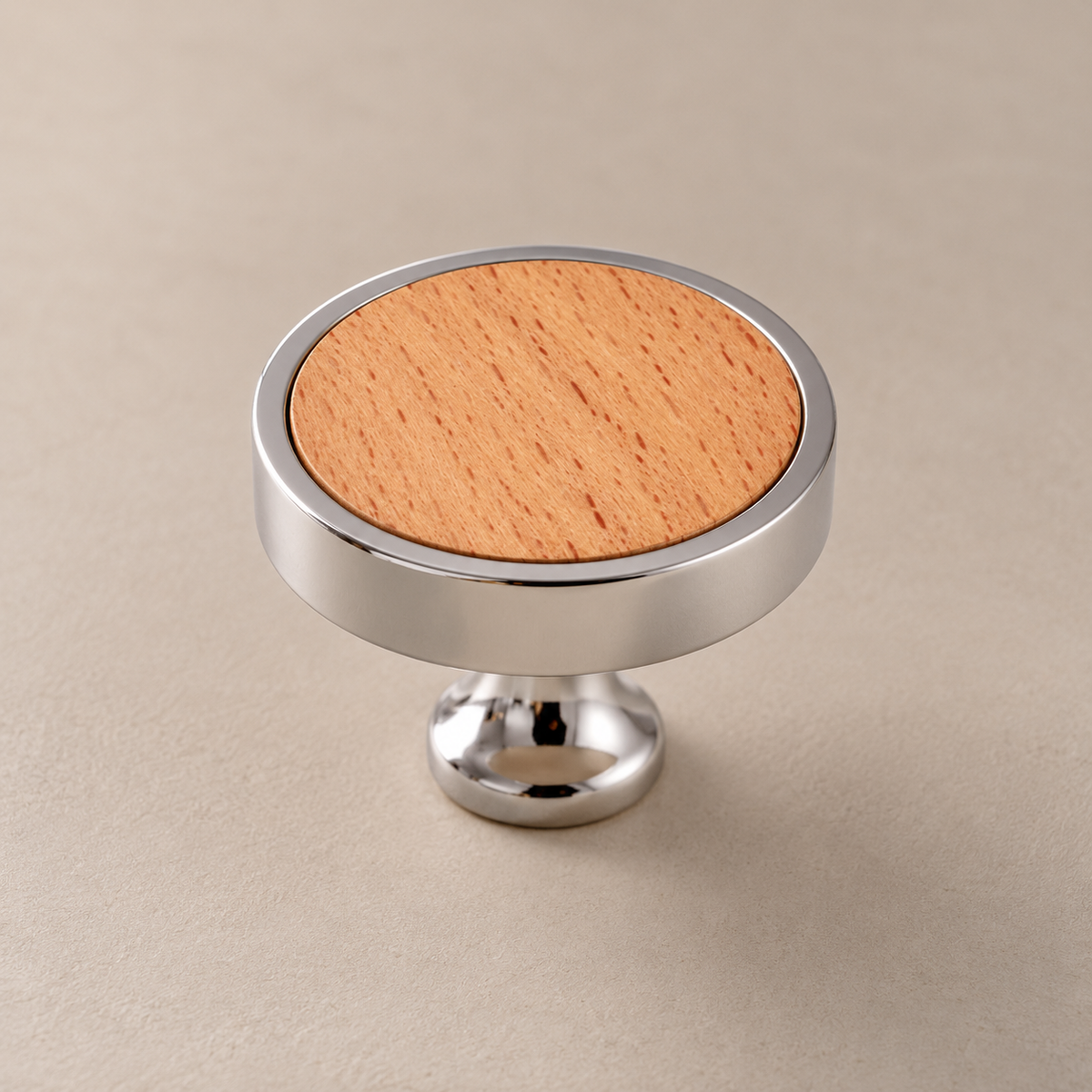 Chrome brass cabinet knob with beech inlay on taupe studio background