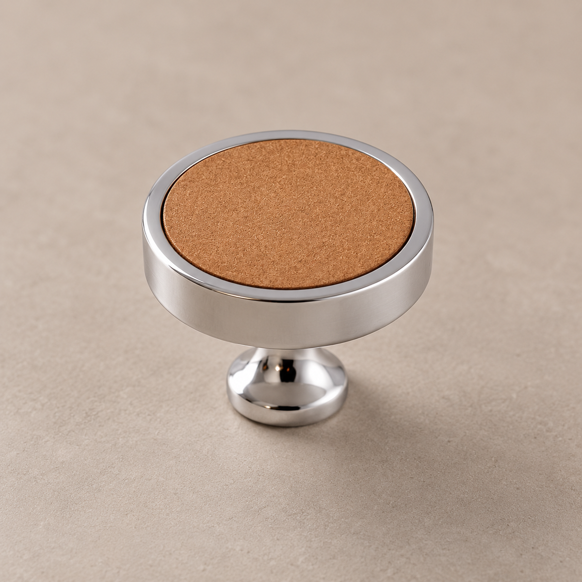Chrome brass cabinet knob with khaki inlay on taupe studio background
