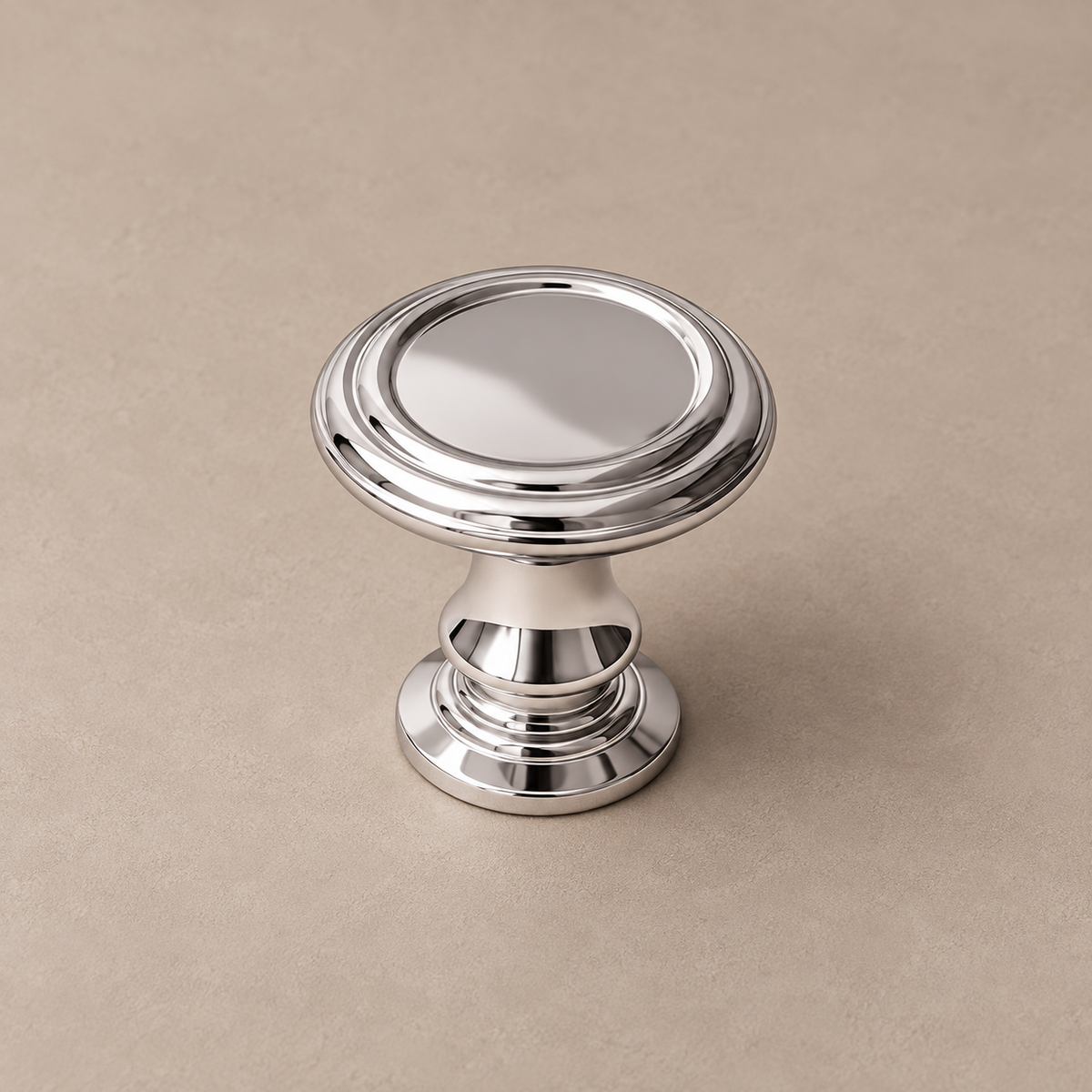 Bright chrome cabinet hardware — support on taupe studio background