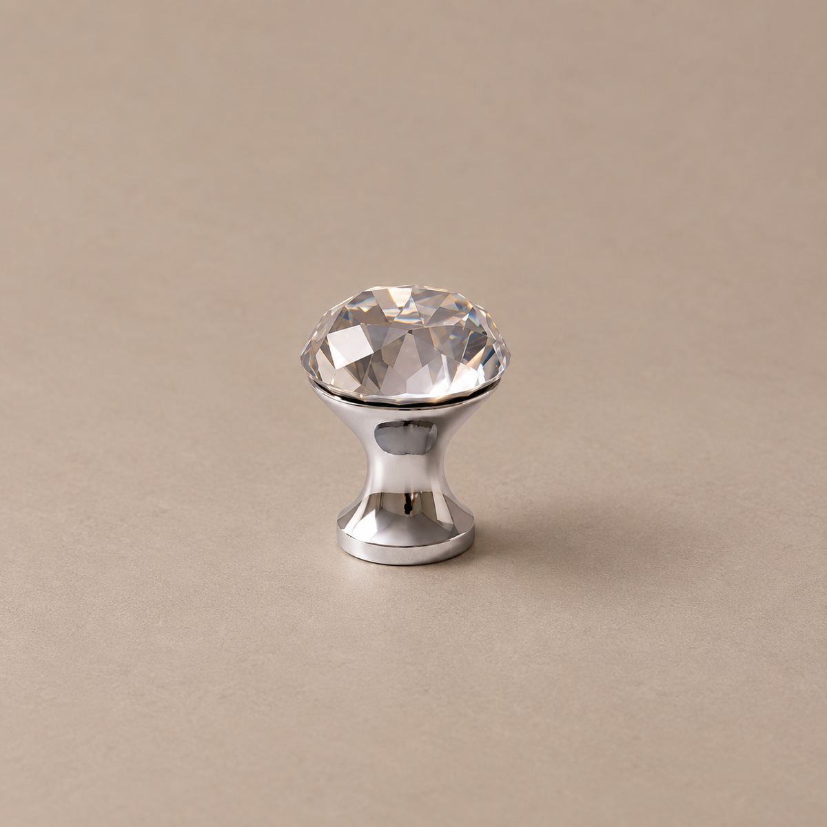 chrome diamond crystal knob on warm taupe studio surface