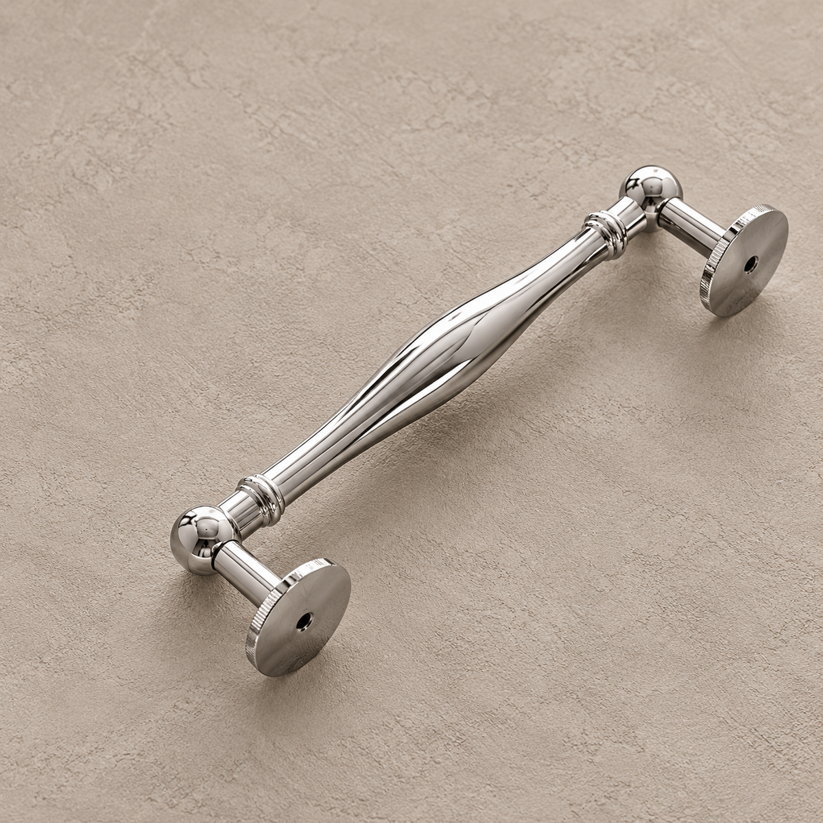 Chrome spindle cabinet pull showing circular mounting feet on taupe plaster