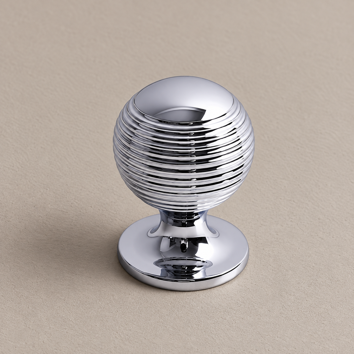 Chrome cabinet pull and ringed knob knob-detail on taupe plaster