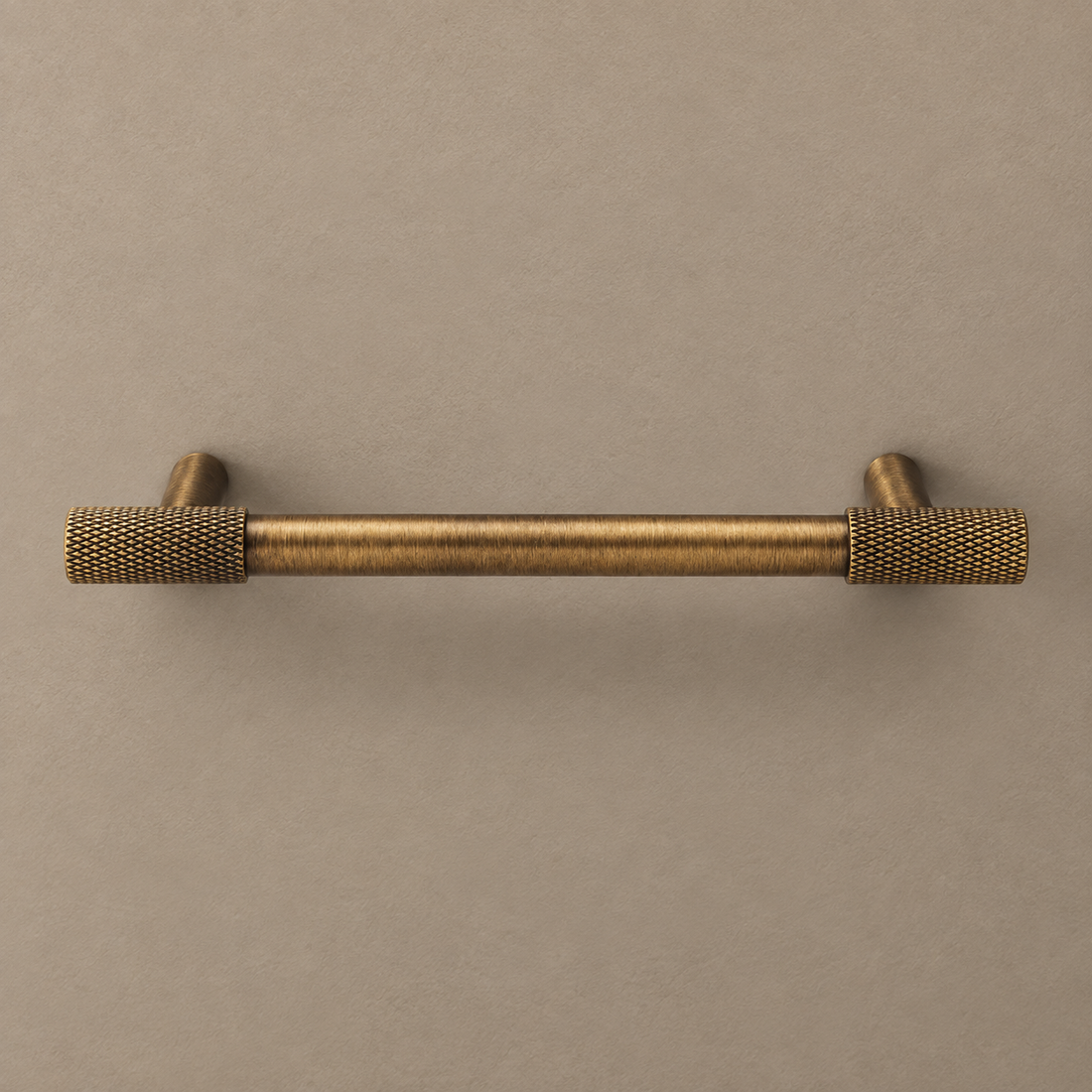 Solid Brass Cross Knurled Cabinet Pulls & Knobs — Antique Brass Finish on a neutral stone studio background