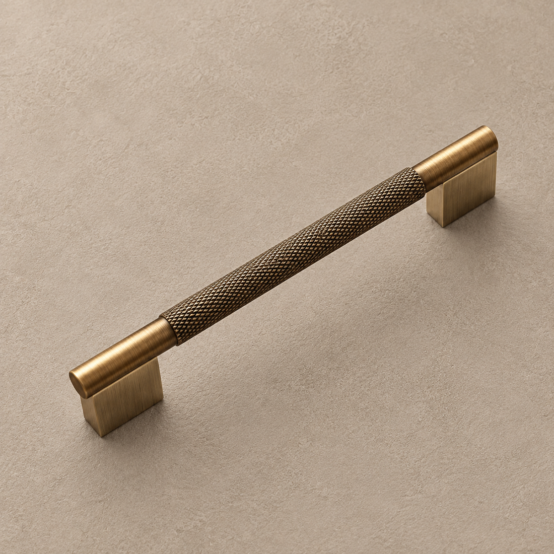 Solid Brushed Antique Brass Cabinet Pull & Knob - Cross Knurled Modern Design on a neutral stone studio background