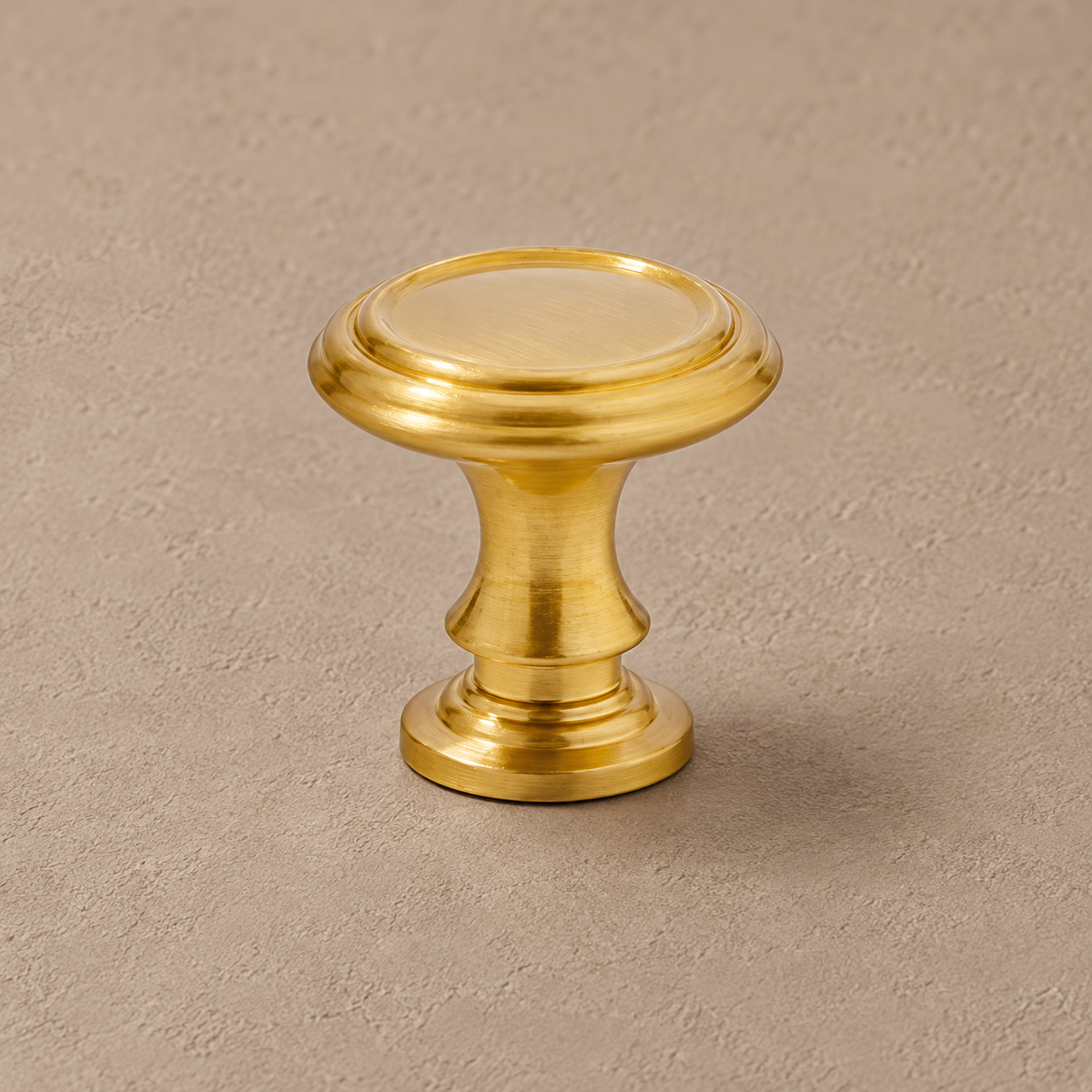 Round brass cabinet knob with concentric rim detail