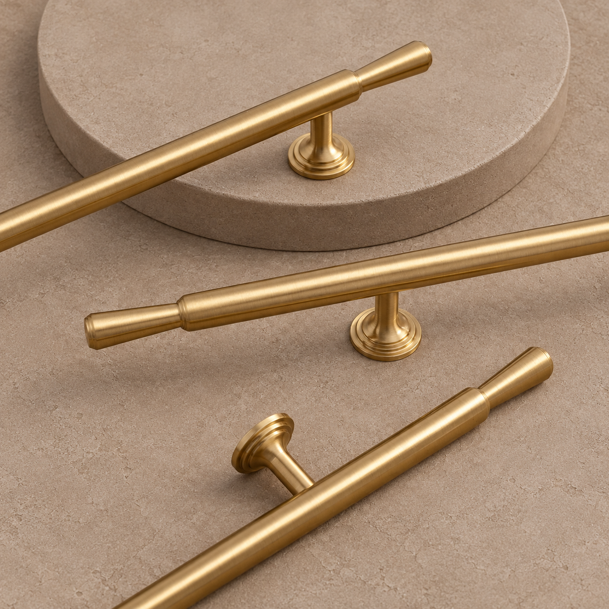Brushed brass pull detail showing tapered finials and round mounting bases