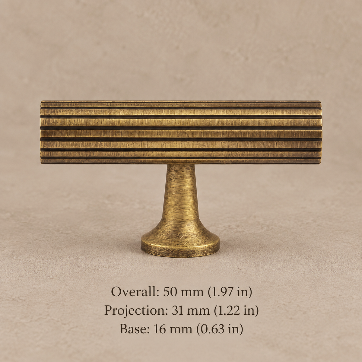 antique brass fluted cabinet knob on warm taupe studio background