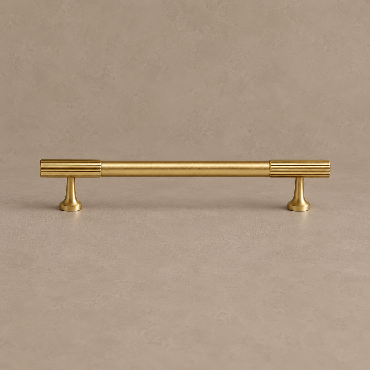 brushed brass fluted cabinet pull on warm taupe studio background