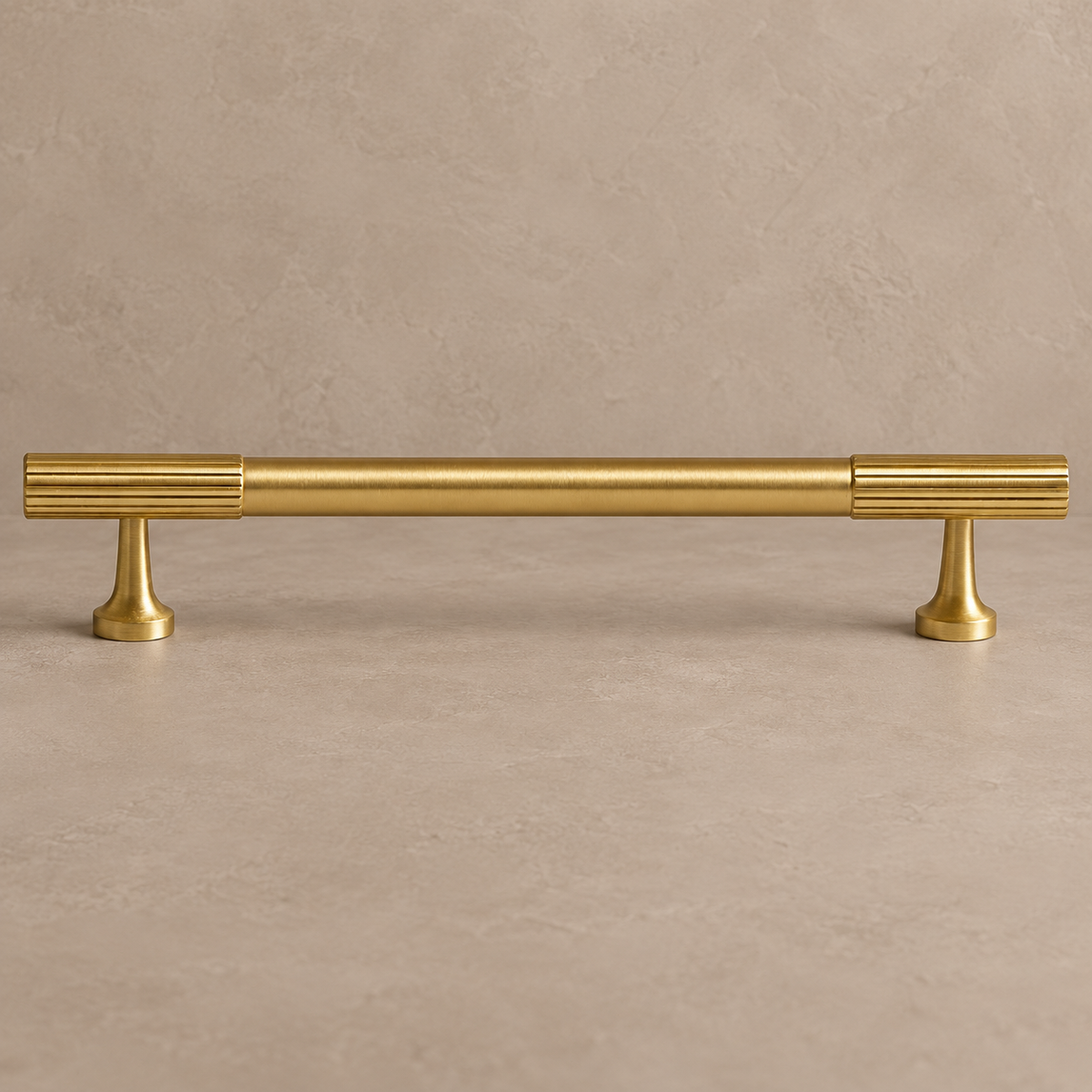 brushed brass fluted cabinet pull on warm taupe studio background