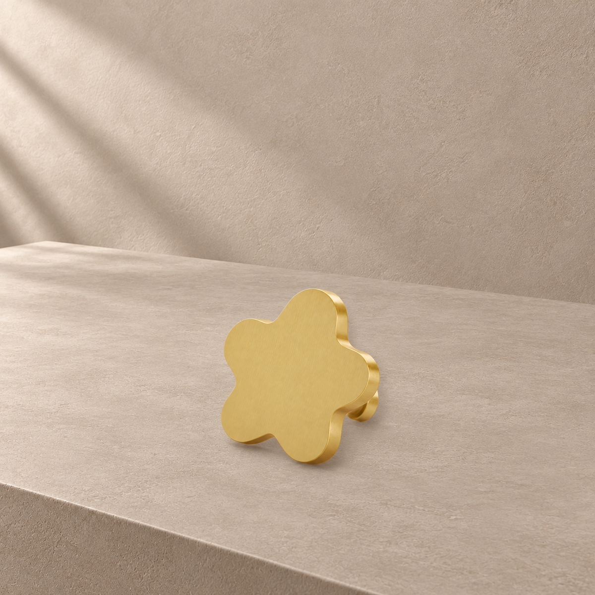 Rounded gold star cabinet knob showing its brushed brass finish