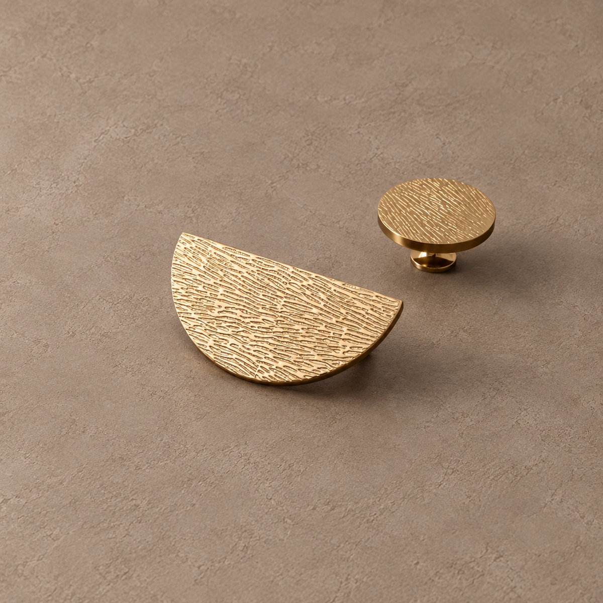 Gold half-moon cabinet pull and matching textured round knob