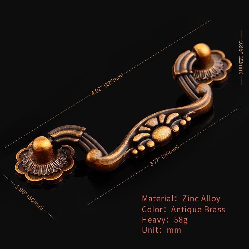 Decorative brass handle with measurements on a black background