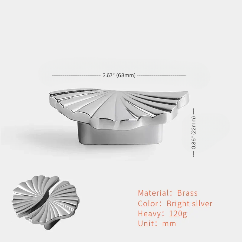 Silver shell-shaped object with dimensions and material details on a white background