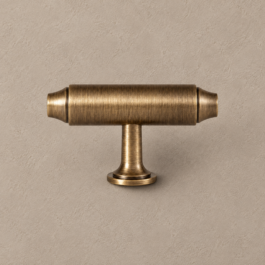 Knuckle Bar Cabinet Pull & Knob — Antique Brass on a neutral stone studio background